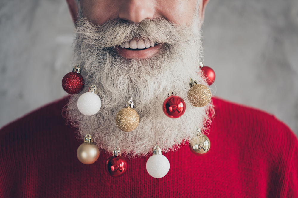 Bartstyles für Weihnachten Headerbild: Mann mit Christbaumkugeln im Bart